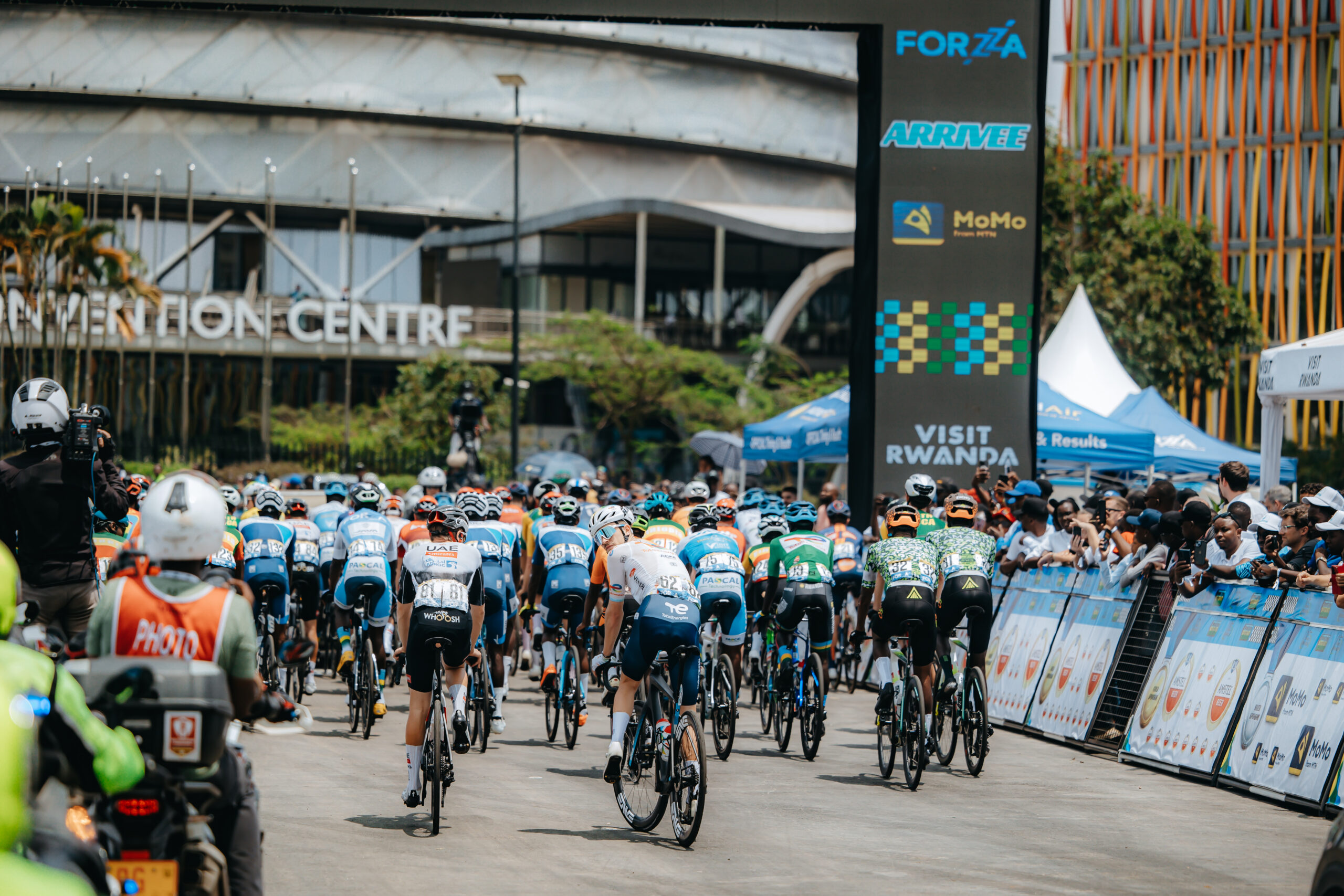 Cyclists competing in the Tour du Rwanda near the Kigali Convention Centre, showcasing Rwanda’s cycling culture ahead of hosting the UCI Road World Championships 2025, the first edition in Africa.