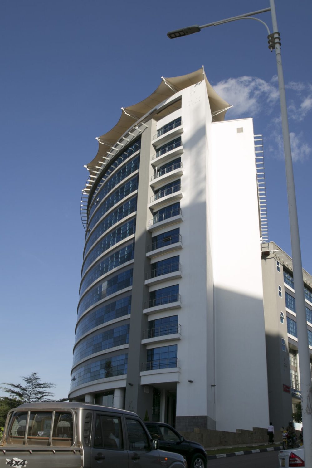 45407805151_184a2c76b8_o A stunning modern high-rise building in Kigali, Rwanda, showcasing the country's clean and organized urban environment. Rwanda is recognized as the safest travel destination in Africa, offering secure and well-maintained cities.