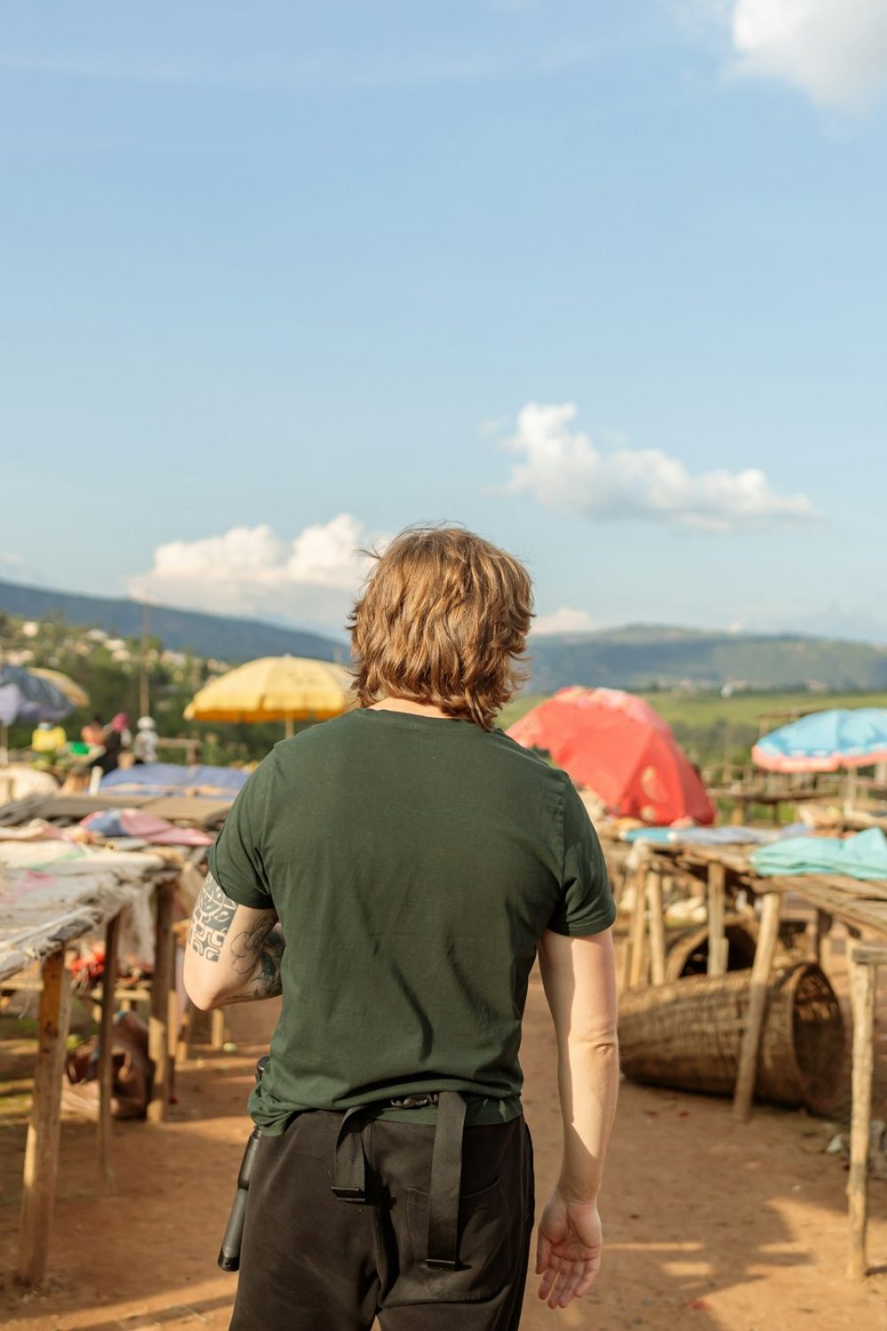 Young man visiting the Kimironko market in Rwanda Young man visiting the Kimironko market in Rwanda